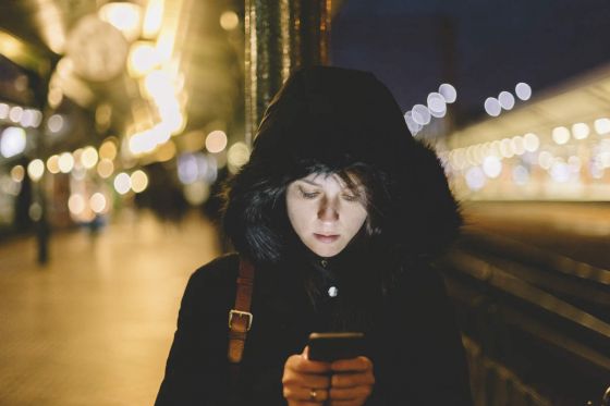 Girl checking her phone at the station