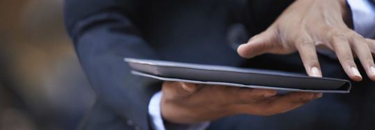 Businessman working on a tablet | Canstar