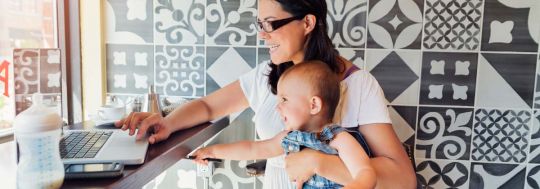Mum working with laptop with baby | Canstar