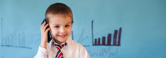 Young Boy in Business Attire on Mobile Phone