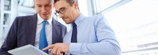 Two businessmen looking at a tablet | Canstar