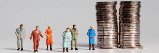 Small people near giant sized money