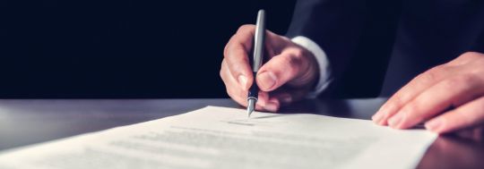 businessman signing document
