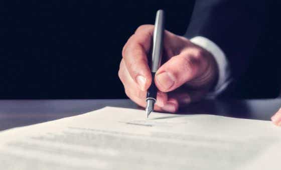 businessman signing document