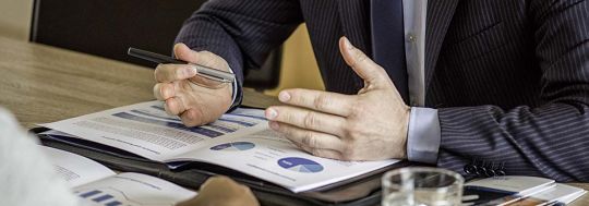 Close up of male hands on business document