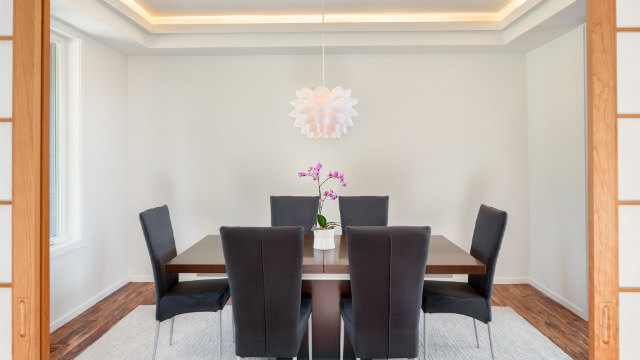 A pendant light over a dining table.