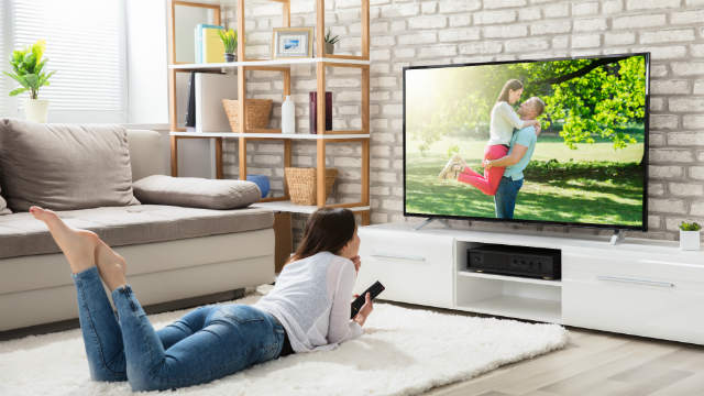 A woman watches TV.