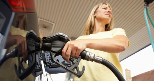 Woman Putting Petrol Into Her Car