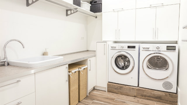 An image of a laundry room with a washer and dryer.