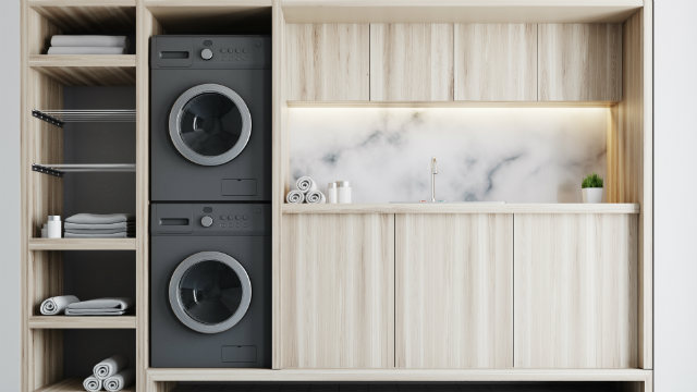 A laundry featuring a marble splashback and a washer and dryer.