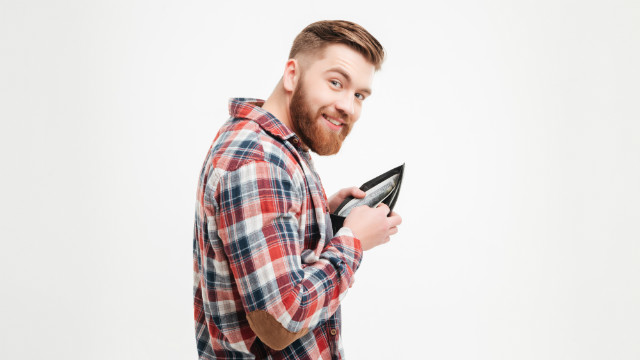 A man puts money into his wallet