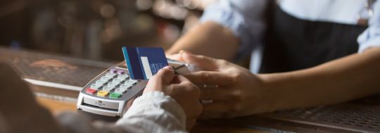 Customer Tapping Eftpos Machine With Card