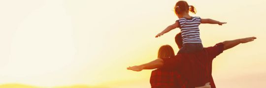Happy family playing aeroplanes