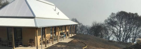 A house in a bushland setting, which has been burnt by bushfire. | Canstar