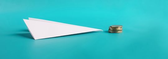 paper plane with coins