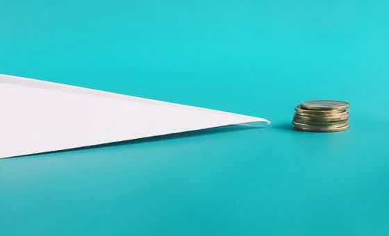 paper plane with coins