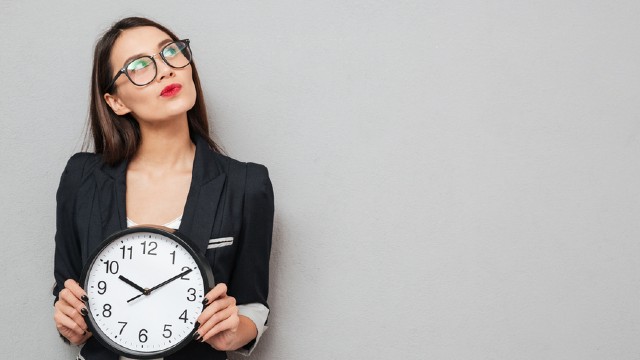 Woman holding clock