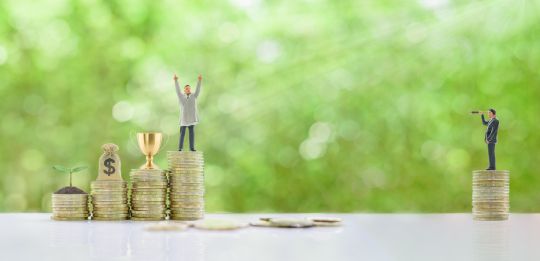 A figure showing a pile of coins and saving is celebrating next to a small pile of coins and sad figure