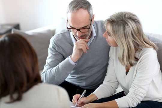 Retirement couple talking to an advisor