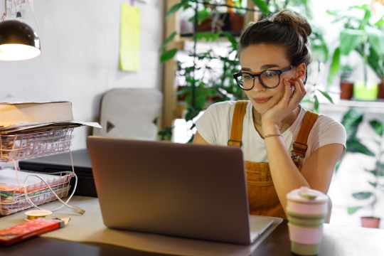 A young woman looking at laptop
