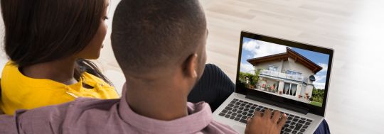 Couple looking at property online