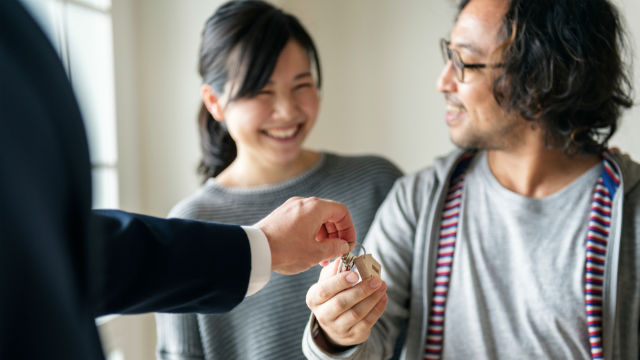 Couple getting keys to house