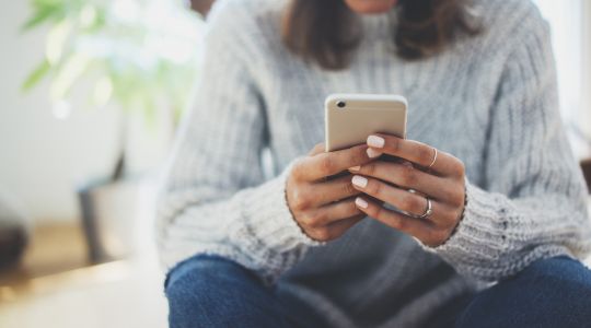 Person holding mobile phone