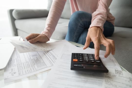 A woman is calculating bills