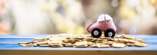 model pink car on coins
