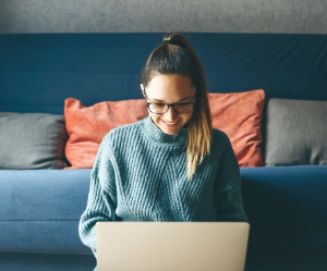 Woman working on laptop in living room
