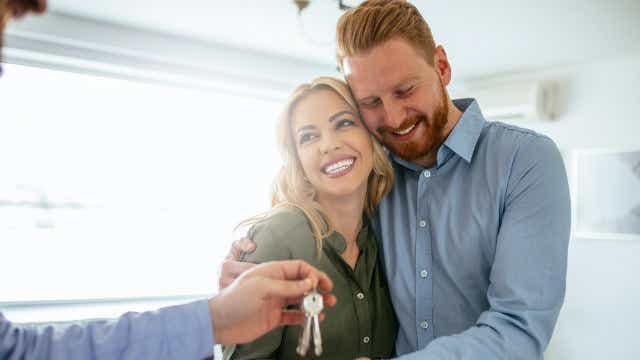 Couple getting keys to a house
