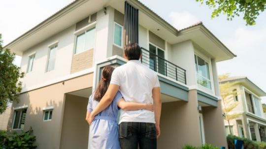 Couple front of first home