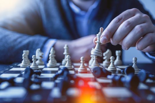 Man in suit playing chess