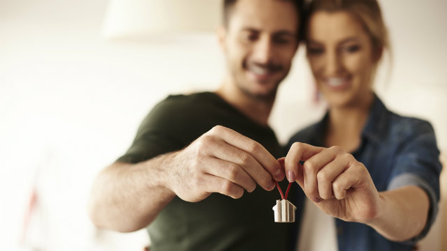 Couple holding house keyring