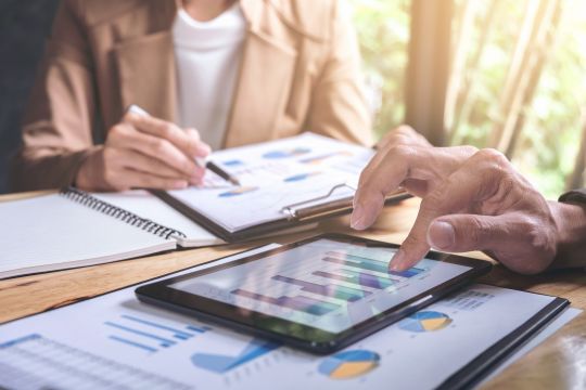 Two people meeting to look at portfolio graphs