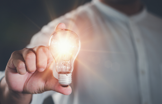 Man holding glowing lightbulb