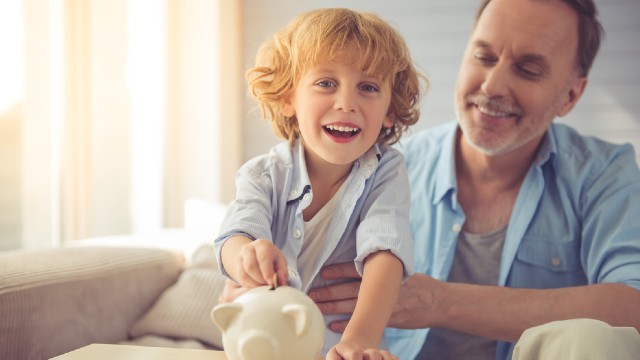 Father and son with piggy bank