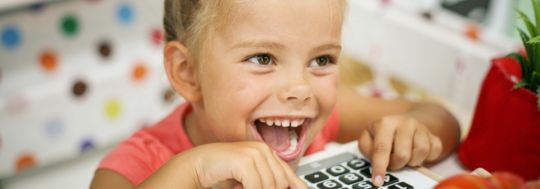 Girl playing with cash register