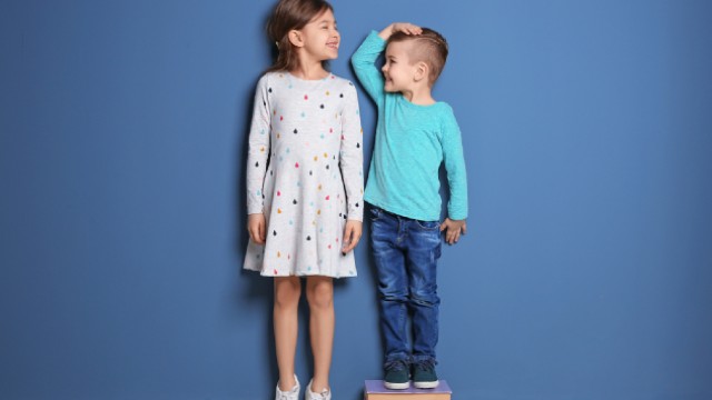 Boy and girl comparing height