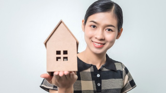 Woman Holding House