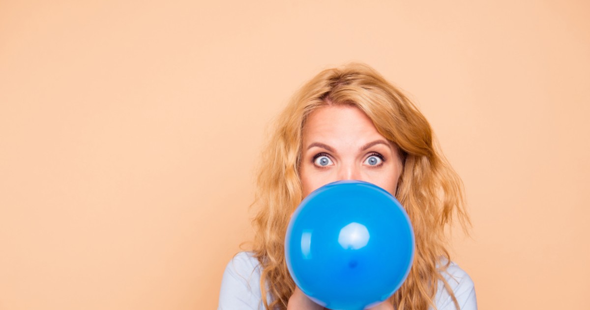 Girls Blowing Balloons