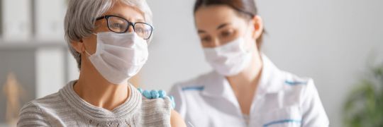 A woman getting a vaccination jab