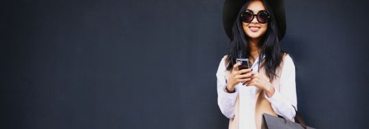 Woman on phone with shopping bag