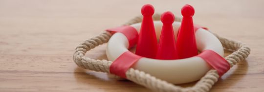 Concept image for life insurance with three people icons in a life preserver