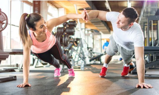 Two people working out in a gym