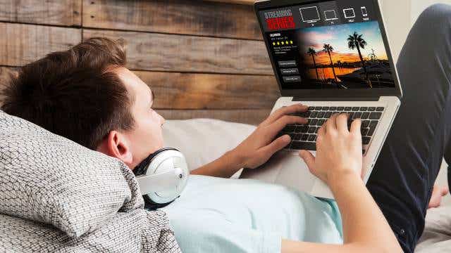 Man streaming show on laptop