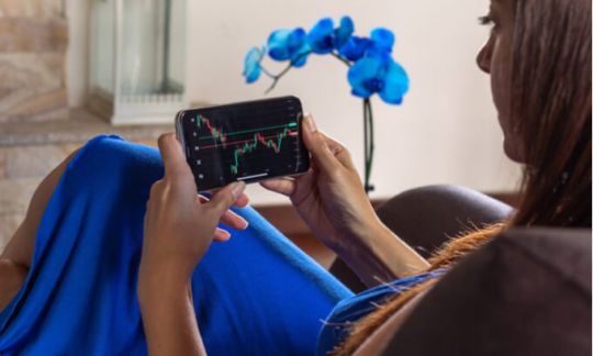 A woman watching her investments on a mobile phone