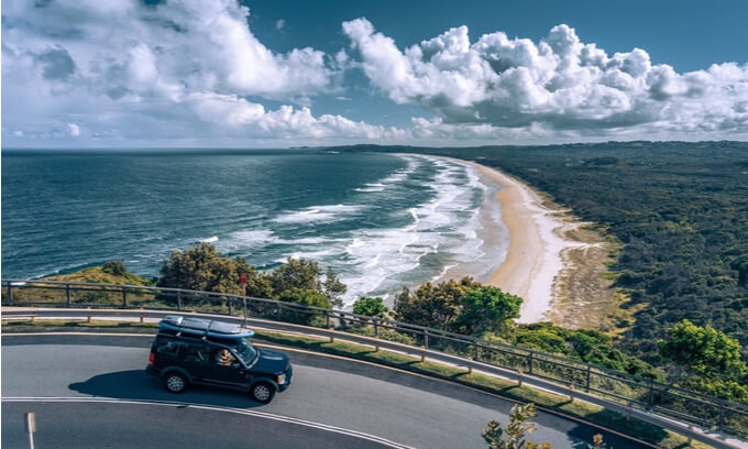 Picturesque lookout at the beach with a car passing by in the foreground