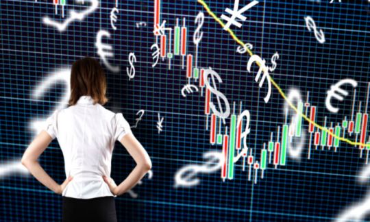A young woman looking at market symbols