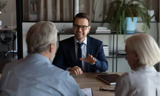 An elderly couple in talks with someone from their super fund